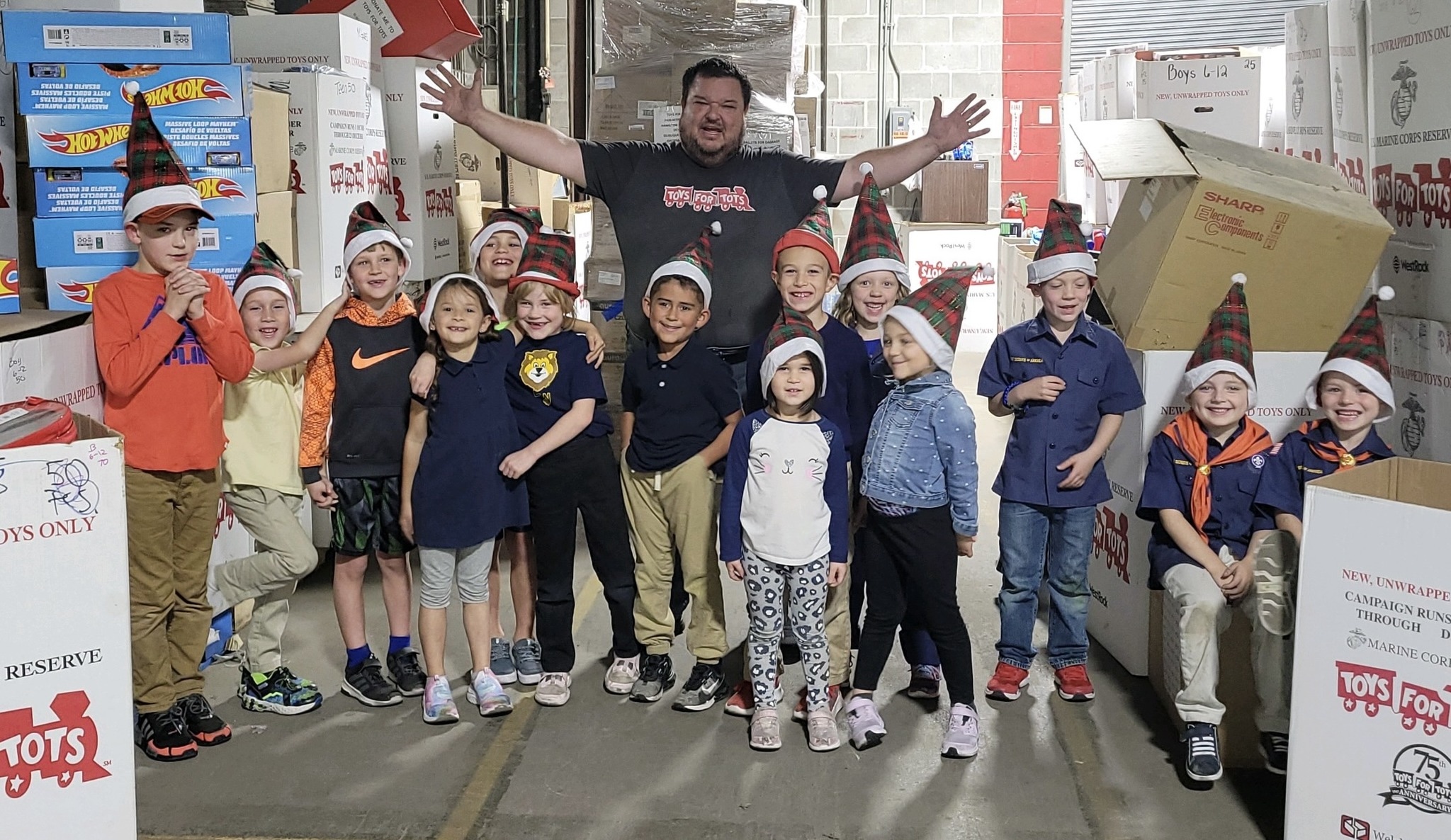 Cub Scout Pack 7 Tigers from Our Lady of Guadalupe help sort toys
